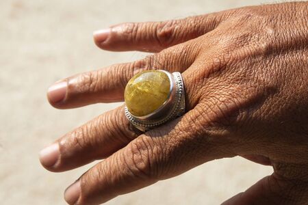 quartz crystal  setting of a ring on man fingerの写真素材