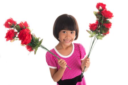 Little asian girl holding a rose on white backgroundの写真素材