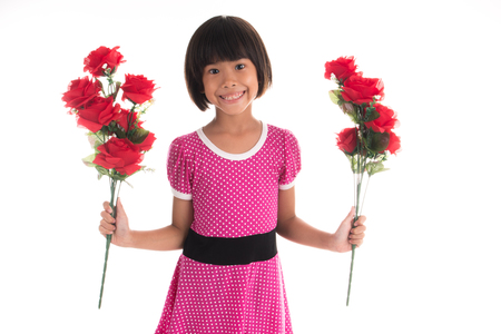 Little asian girl holding a rose on white backgroundの写真素材