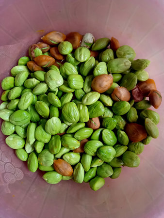 Pistachio nuts in a bowl on the market in Thailand.