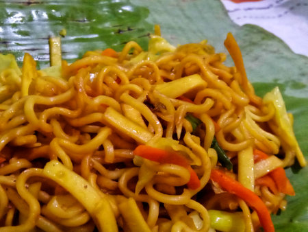 Fried noodle with vegetables on the table in the restaurant.の写真素材