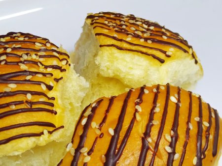 Bread with chocolate and sesame seeds on a white background.の写真素材