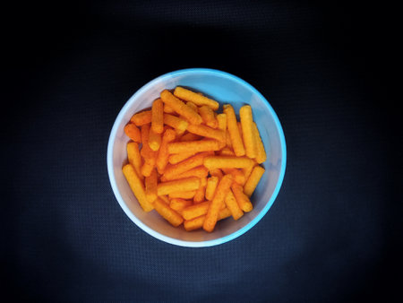 Bowl of snack on black background. Top view.の写真素材