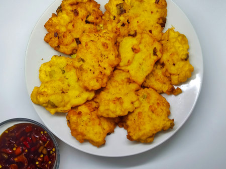 Fried cauliflower with sweet and sour sauce on white plate.の写真素材