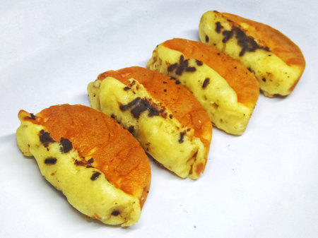 baked dumplings with raisins on a white backgroundの写真素材