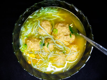 Vietnamese noodle soup with meatballs in a glass bowlの写真素材
