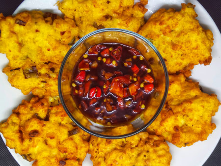 Potato pancakes with chili sauce on a white plate, top viewの写真素材