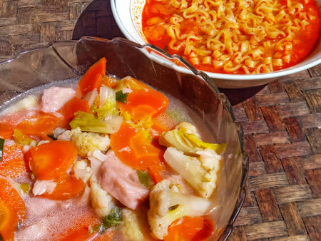 Thai style noodle soup with chicken and vegetables in a bowlの写真素材
