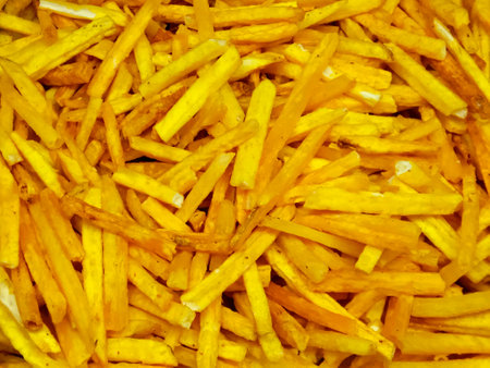 Golden French fries potatoes background. Top view. Close up. Selective focus.