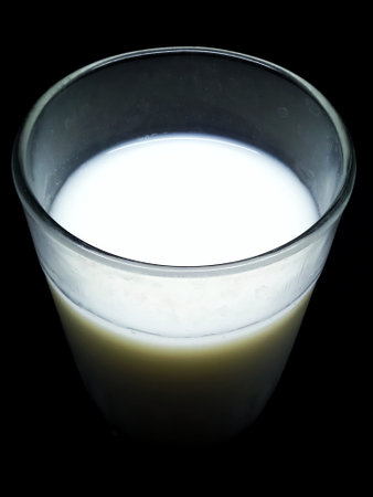 A glass of milk on a black background, close-up.の写真素材
