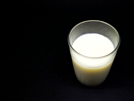 A glass of milk on a black background. Free space for text.の写真素材