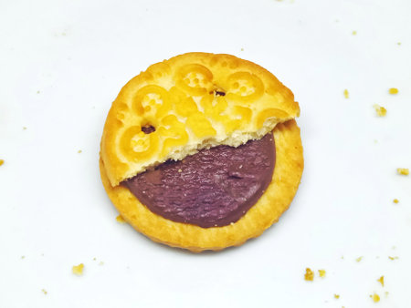 Biscuit with black currant jam on a white background.の写真素材