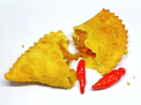 Fried dumplings with red and yellow peppers on a white backgroundの写真素材