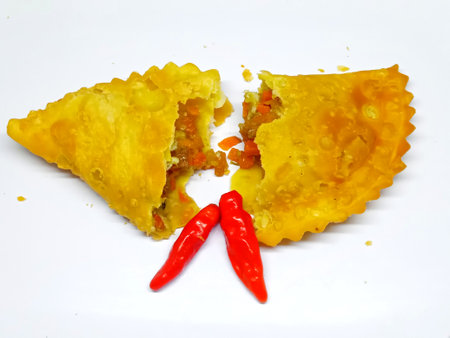 Fried dumplings with vegetables and chili peppers on a white backgroundの写真素材