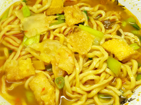 Noodles with chicken and vegetables in a bowl, close upの写真素材