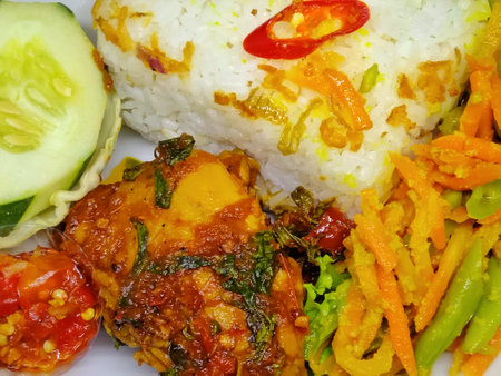 Close up of thai style fried chicken with rice and vegetables.の写真素材