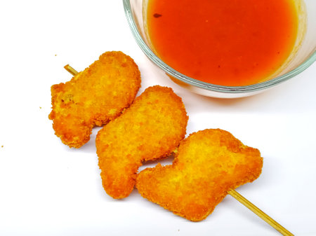 Fried chicken nuggets with sweet sauce isolated on white background.の写真素材