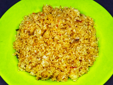 Fried rice in a green plate on a black background. Top view.の写真素材