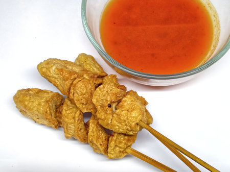 Deep fried pork rind with sweet and sour sauce on white backgroundの写真素材
