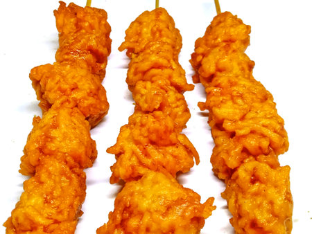 Fried chicken skewers on a white background, close-up.の写真素材