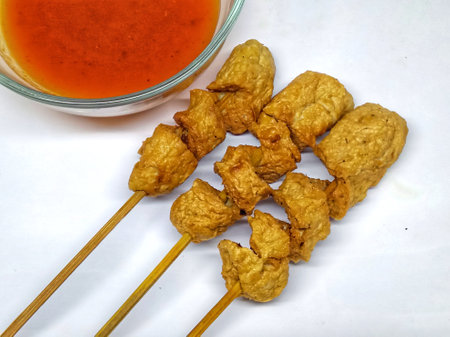 Deep fried pork rind with sweet and sour sauce on white backgroundの写真素材