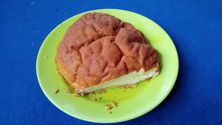 Delicious cheesecake slice on a green plate, ideal for food blogs, desserts, and culinary...