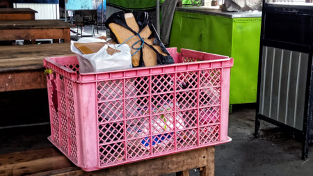 Durable pink plastic container for organizing and storing household items, ideal for decluttering and home organization.の写真素材