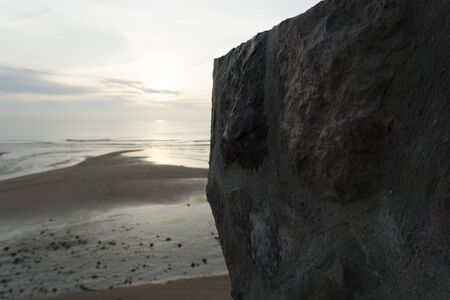 Beautiful dawn, morning sun rises by the sea. Scenic beach, coastline, rocks, cloudscape and skyline...
