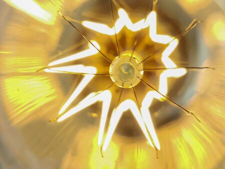 Electricity current inside a retro crystal clear light bulb.