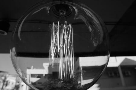 Amazing spiral electric current inside a retro crystal clear light bulb.の写真素材