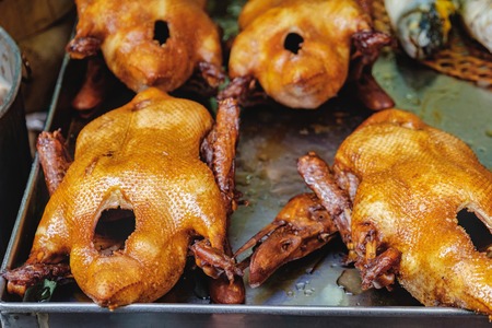 Peking duck roasted for sale at street market of Chinatown district in Bangkok, Thailand. Traditional chinese cuisine. Top view. Selective focusの写真素材