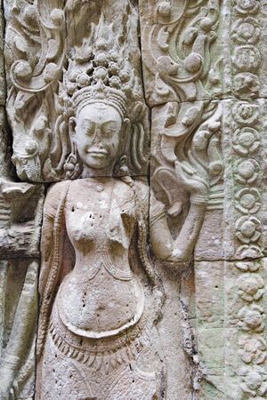 Dancing Apsaras an old Khmer art carvings on the wall in Angkor Wat temple near Siem Reap town, Cambodiaの写真素材