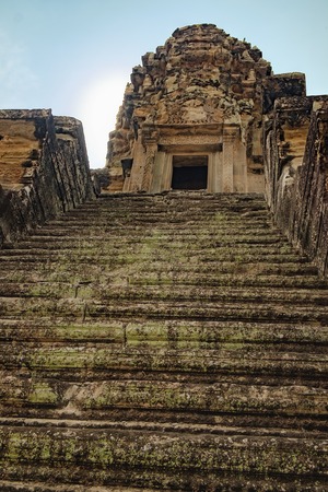 Stone old steps covered with moss to the top of the Angkor Wat stone tower, Siem Reap, Cambodia.の写真素材