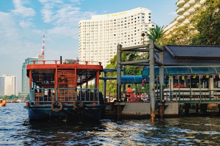 Bangkok, Thailand - January 9, 2016: Oriental Pier is the first pier of Chao Phraya Express Boat, popular boat travel and tourist attractions on both sides of the river. CAT Tower is in the backgroundのeditorial素材