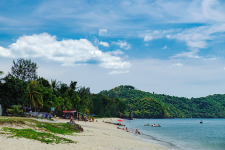 Langkawi, Malaysia - February 14, 2016: Summer vacation on the Pantai Tengah Beach, Langkawi, Malaysia. Unidentified tourists relax on paradise beach, sunbathe and swimのeditorial素材