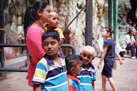 Batu Caves, Malaysia - February 7, 2016: Malaysian Hindu people visit to the the most popular Hindu shrines Batu Caves. Hindu family of Mom and her little sons inside the cavesのeditorial素材
