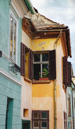 Windows with open shutters in a medieval house in the historic center of Sighisoara, Romaniaの写真素材