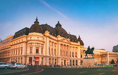 Central University Library and Carol I statue on horse on Calea Victoriei at sunset, Bucharest, Romaniaのeditorial素材