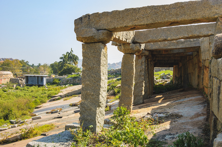 View of ancient ruins of Hemakuta hill in Hampi, Karnataka, India. Landscape with amazing stones, tropical nature and temple in the foreground.の写真素材