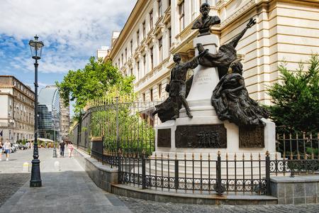 Bucharest, Romania - September 9, 2017: Tourists visiting the historical center Lipscani Street with its beautiful architecture, Bucharest, Romania. Monument to Eugeniu Carada in the foreground.のeditorial素材
