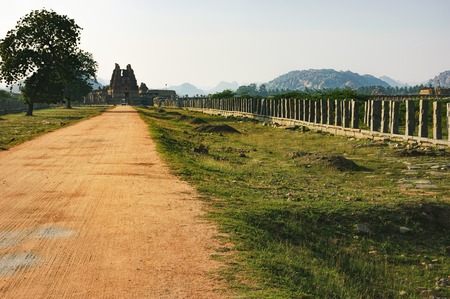 Market complex near temple tank Pushkarani on the way to the Vitthala temple, Hampi, Karnataka, India. Sandy road to the temple. Ancient ruins of Vijayanagara Empire.の写真素材
