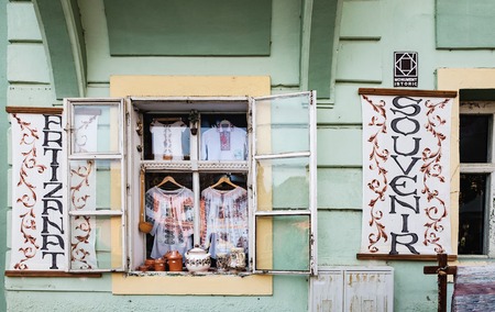 Sighisoara, Romania - September 28, 2017: Souvenirs for tourists shopping at old historic center of the town near Sighisoara Clock Tower. Handmade national clothes with embroidery in memory of journeyのeditorial素材