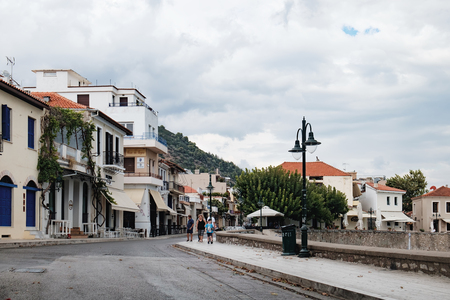 Nafpaktos, Greece - September 20, 2017: Tourists walking along the embankment of the Nafpaktos town situated on a bay on the north coast of the Gulf of Corinth, West Greeceのeditorial素材