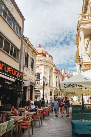 Bucharest, Romania - September 9, 2017: Old Town street cafe with people at the Smardan Street in historical center of Bucharest with its beautiful architecture, Romania.のeditorial素材