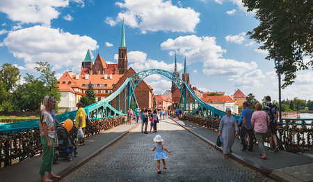 Wroclaw, Poland - August 17, 2018: A little girl dancing on the Tumski Bridge known as the Lovers Bridge. This place is full of love locks and an important tourist attraction of Wroclaw Old Townのeditorial素材