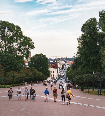 Oslo, Norway - August 3, 2018: People walk Oslo's main street Karl Johans gate at the Slottsplassen, Royal palace area. Sunset time.のeditorial素材
