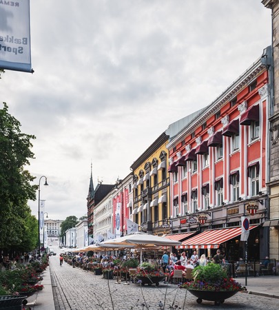 Oslo, Norway - August 3, 2018: People sightseeing and relaxing in outdoors cafes in Karl Johans gate, the main street of the city of Oslo. The Royal Palace is seen in the backgroundのeditorial素材