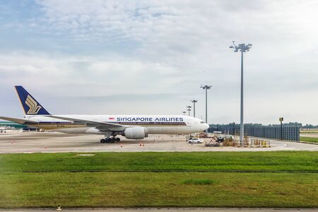 Singapore - January 20, 2018: Singapore Airlines Boeing 777-200 docked at Changi International Airport in Singapore, view from the runwayのeditorial素材