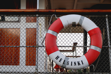 Lifeline with Helsinki inscription is on an old yacht moored at the pier in Finlandの写真素材