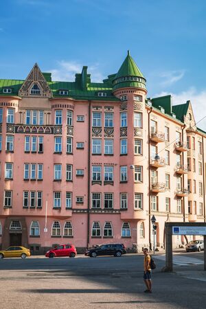 Helsinki, Finland - July 25, 2018: Tourists walk and enjoy old beautiful architecture in Agricolankatu Street, historical center of Helsinki, Finland. Sunset timeのeditorial素材